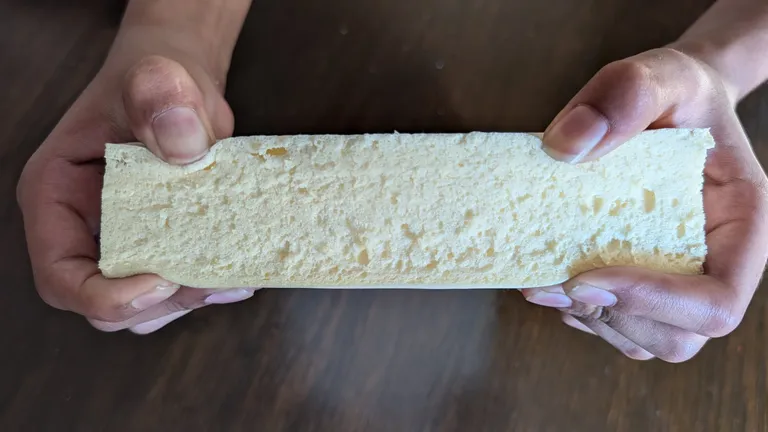 A Super Foam elastomer sample flexed by hand