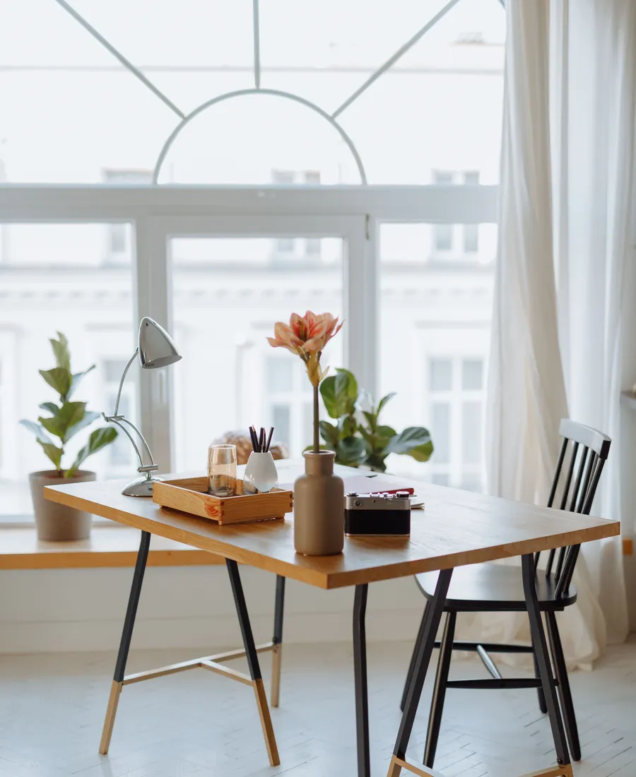 Sunlit desk and living space showing an orderly, practical everyday environment