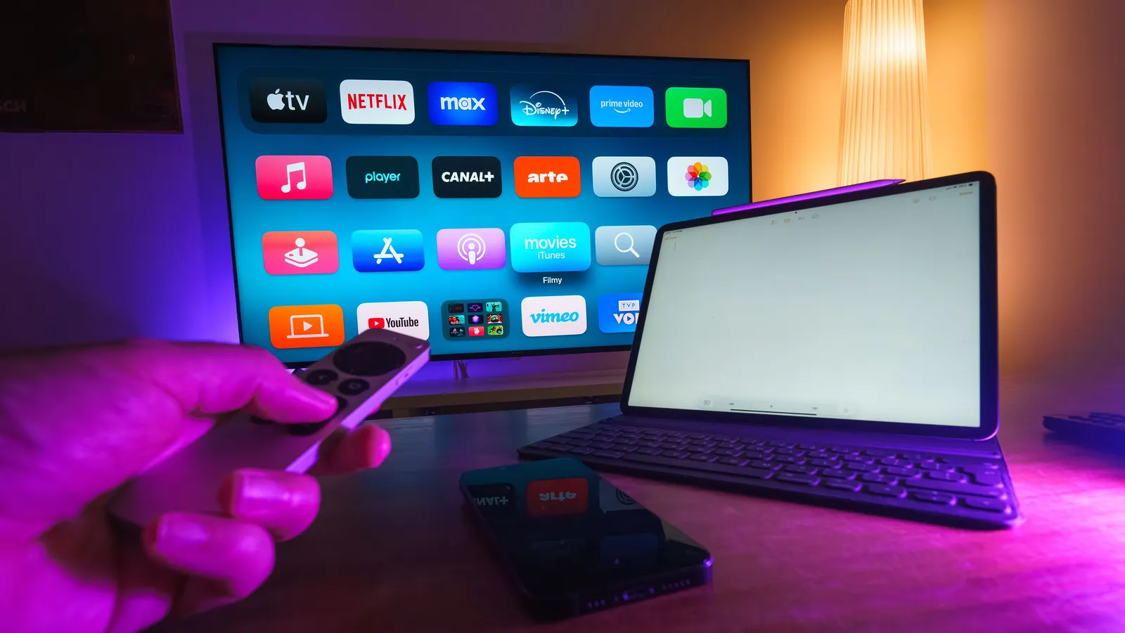 Split-screen comparison of live TV streaming and an on-demand library in a warm modern UK living room
