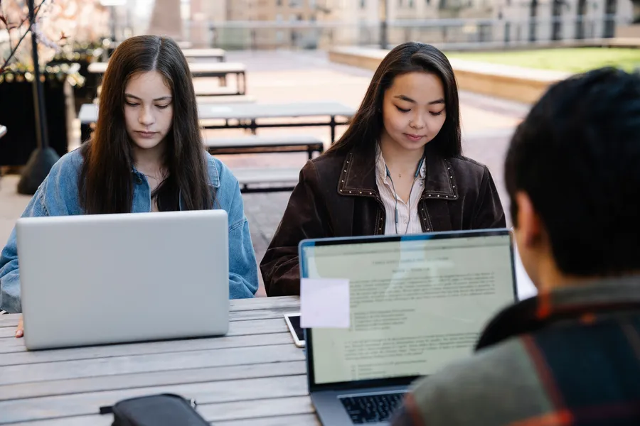 Students collaborating over notes in a bright study space