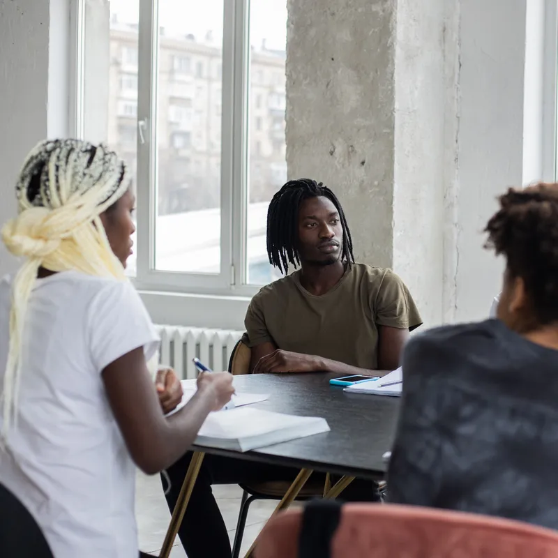 Diverse students planning together at a community meeting