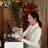 Side&nbsp;view&nbsp;of&nbsp;smiling&nbsp;young&nbsp;Asian&nbsp;female&nbsp;cashier&nbsp;wearing&nbsp;apron&nbsp;using&nbsp;modern&nbsp;cash&nbsp;desk&nbsp;with&nbsp;computer&nbsp;screen&nbsp;in&nbsp;cafe&nbsp;with&nbsp;rustic&nbsp;wooden&nbsp;interior