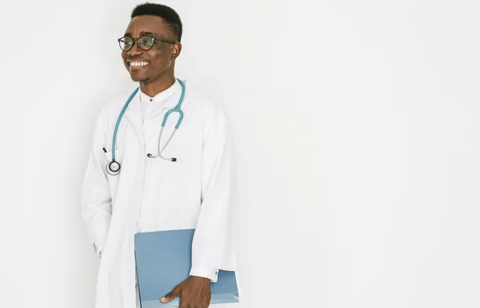 Confident&nbsp;doctor&nbsp;with&nbsp;stethoscope&nbsp;and&nbsp;folder,&nbsp;exuding&nbsp;professionalism&nbsp;and&nbsp;warmth.