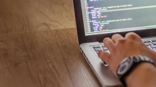 Close-up&nbsp;of&nbsp;a&nbsp;person&nbsp;coding&nbsp;on&nbsp;a&nbsp;laptop,&nbsp;showcasing&nbsp;web&nbsp;development&nbsp;and&nbsp;programming&nbsp;concepts.