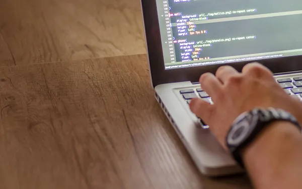 Close-up&nbsp;of&nbsp;a&nbsp;person&nbsp;coding&nbsp;on&nbsp;a&nbsp;laptop,&nbsp;showcasing&nbsp;web&nbsp;development&nbsp;and&nbsp;programming&nbsp;concepts.