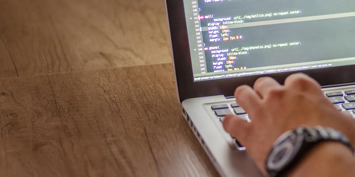 Close-up&nbsp;of&nbsp;a&nbsp;person&nbsp;coding&nbsp;on&nbsp;a&nbsp;laptop,&nbsp;showcasing&nbsp;web&nbsp;development&nbsp;and&nbsp;programming&nbsp;concepts.