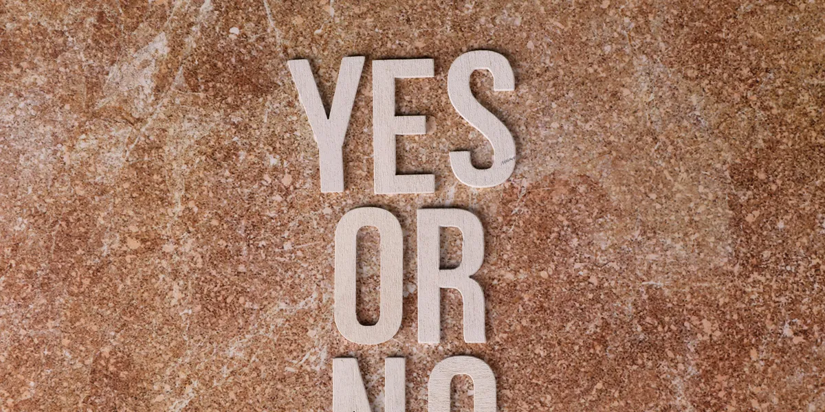 Wooden&nbsp;letters&nbsp;on&nbsp;marble&nbsp;background&nbsp;spell&nbsp;'YES&nbsp;OR&nbsp;NO'&nbsp;symbolizing&nbsp;choices.