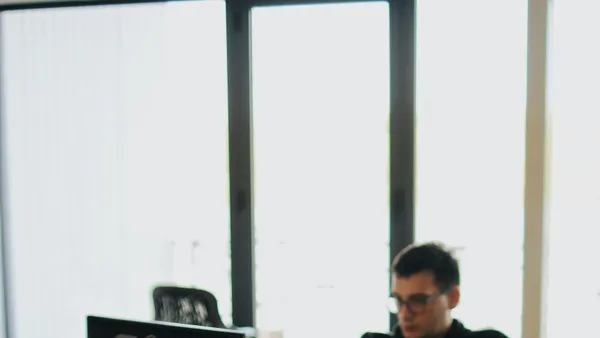A&nbsp;web&nbsp;developer&nbsp;working&nbsp;on&nbsp;code&nbsp;in&nbsp;a&nbsp;modern&nbsp;office&nbsp;setting&nbsp;with&nbsp;multiple&nbsp;devices.