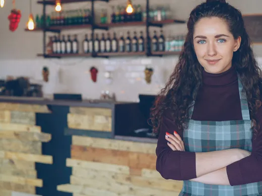 Local&nbsp;shop&nbsp;owner&nbsp;smiling&nbsp;behind&nbsp;the&nbsp;counter