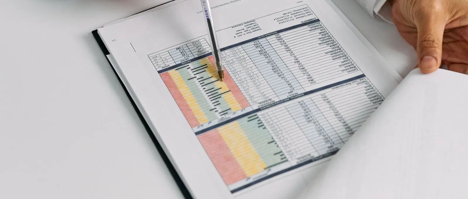 A doctor reviews information at a desk in a bright medical office.