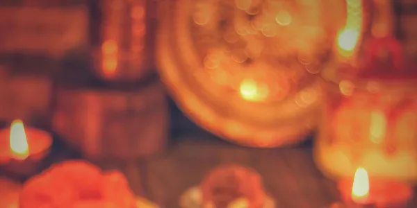 A&nbsp;warm&nbsp;display&nbsp;of&nbsp;Indian&nbsp;sweets&nbsp;and&nbsp;diyas&nbsp;celebrating&nbsp;a&nbsp;festive&nbsp;occasion&nbsp;indoors.