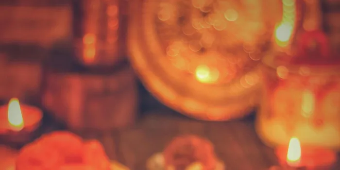 A&nbsp;warm&nbsp;display&nbsp;of&nbsp;Indian&nbsp;sweets&nbsp;and&nbsp;diyas&nbsp;celebrating&nbsp;a&nbsp;festive&nbsp;occasion&nbsp;indoors.