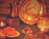 A&nbsp;warm&nbsp;display&nbsp;of&nbsp;Indian&nbsp;sweets&nbsp;and&nbsp;diyas&nbsp;celebrating&nbsp;a&nbsp;festive&nbsp;occasion&nbsp;indoors.