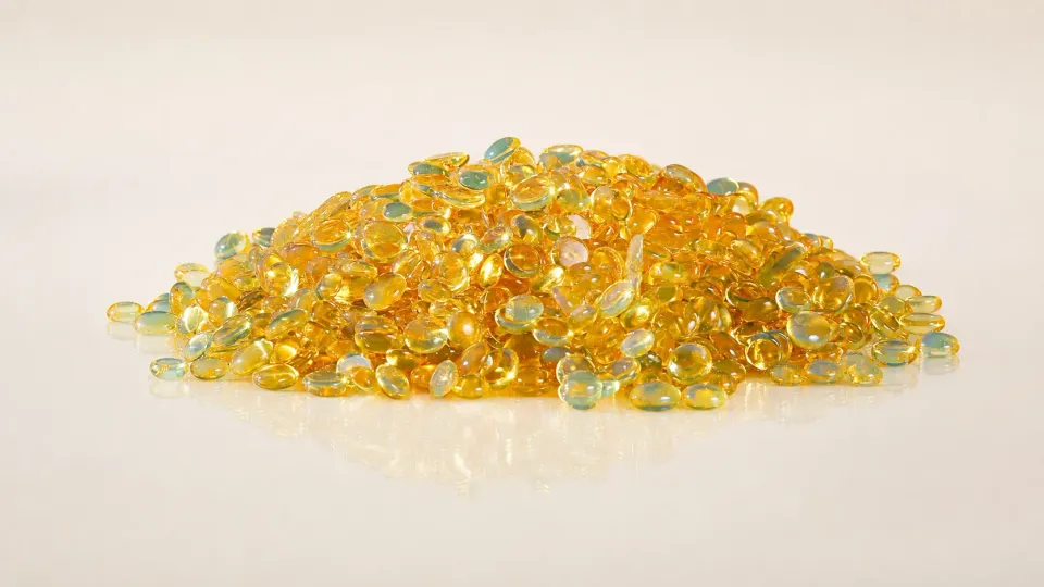 Amber resin granules on a light surface