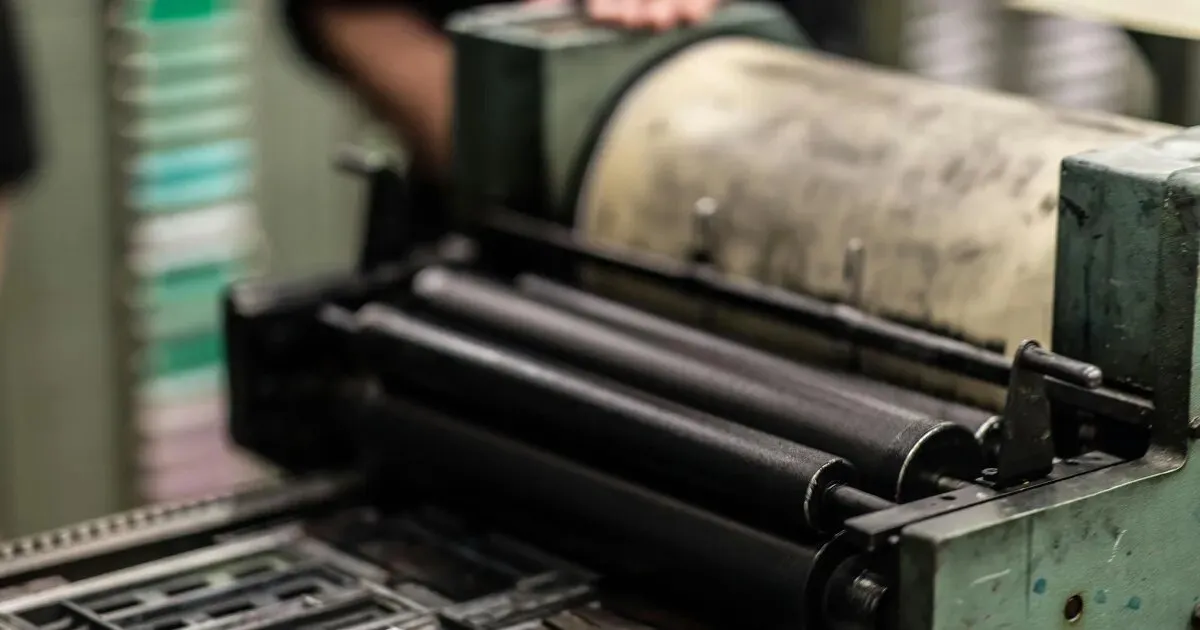 Printing press rollers in an industrial printing facility